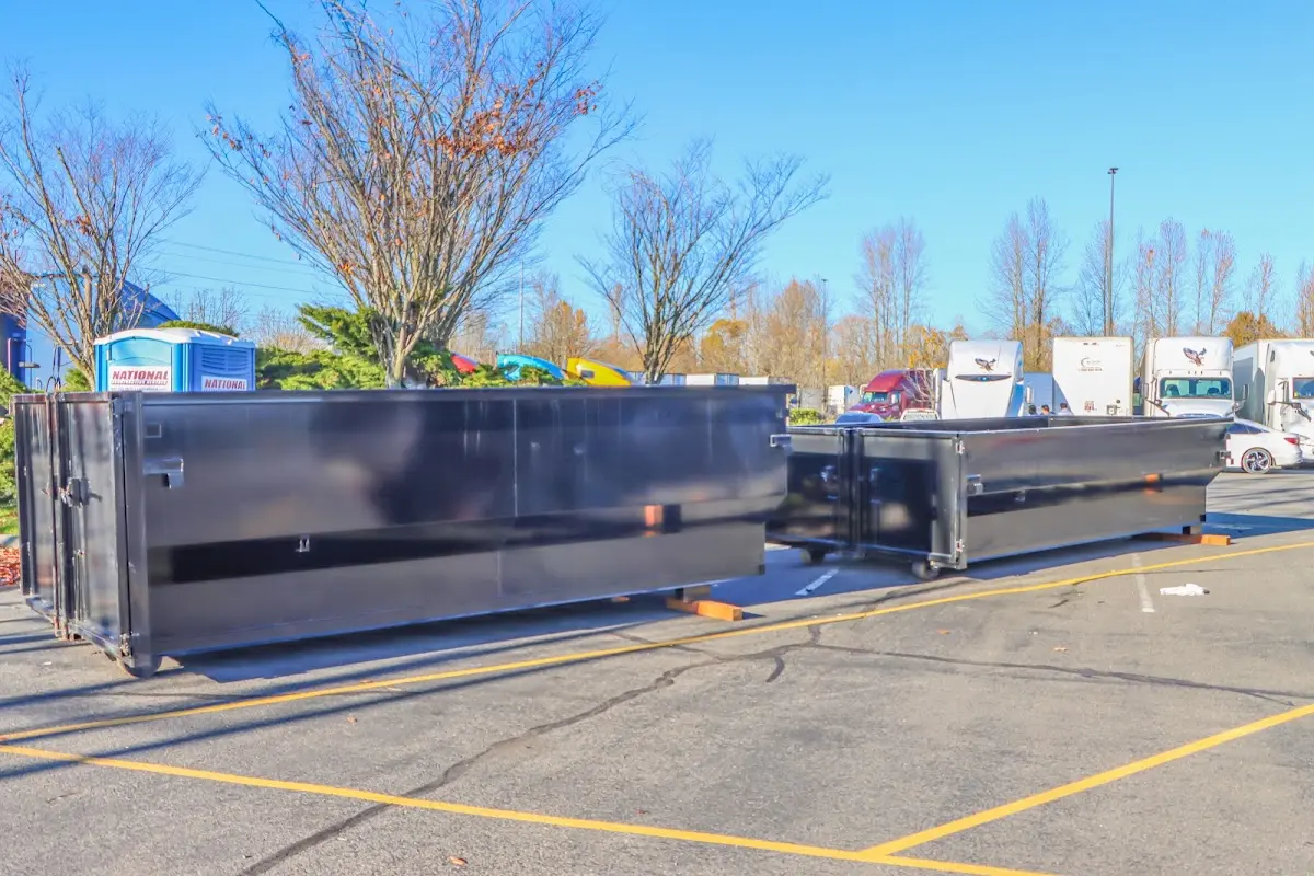 Professional dumpster rental service with roll-off container on residential driveway in Stroud